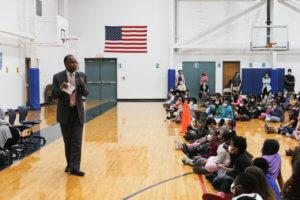 Dr. Ben Carson presenting in front of students at NBCA