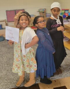 3 Macomb Montessori Academy students pose in the classroom as their favorite African American Historical Figures in the classroom