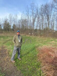 Facilities Director Lonny stands where the newly erected boardwalk is within WMAES' Wetlands Habitat